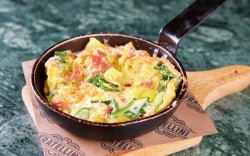 Tortilla espanola: spanish omlette with potatoes, bacon, spinach, onions and red peppers image