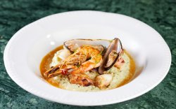 Creamy risotto with seafood,and semi dry doc white wine image