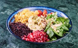 Buddah bowl - baby spinach, hummus, seeds, lentils, brown rice, pomegranate and cherry tomatoes image