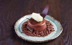 Coconut Mousse covered in chocolate with pineapple Sauce image