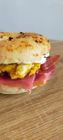 Prosciutto and scrambled egg bagel image
