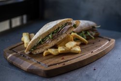 Porchetta sandwich served with fries image