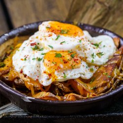 Sunny side up eggs with french fries, bacon and cheddar cheese  image