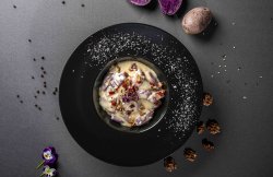 Gnocchi di patate viola con fonduta di formaggi speck e noci image